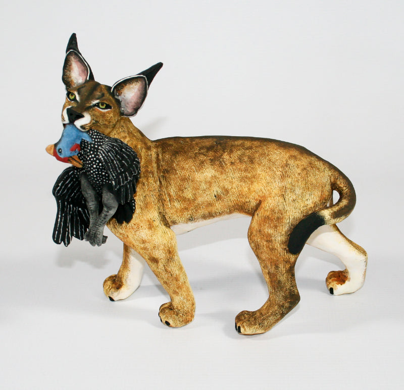 Caracal with Peacock Prey