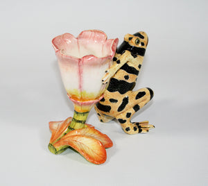 Yellow frog with black speckled spots and pink and white flower candle holder