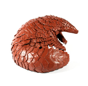 Large Brown Brushed Pangolin sitting curled