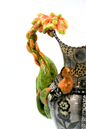 Yellow and black hoopoe and flower jug