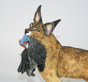 Serval Cat with Peacock Prey
