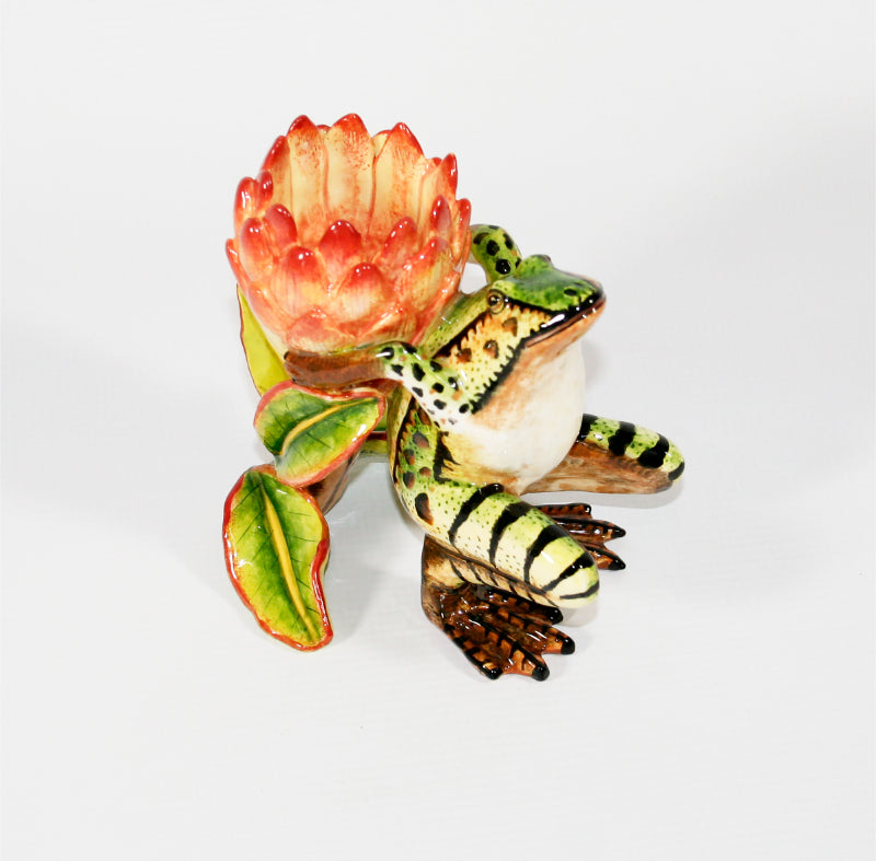 Green and brown frog with pink protea candle holder
