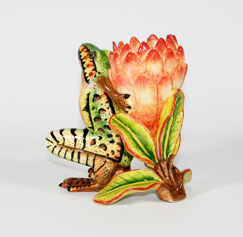 Green and brown frog with pink protea candle holder