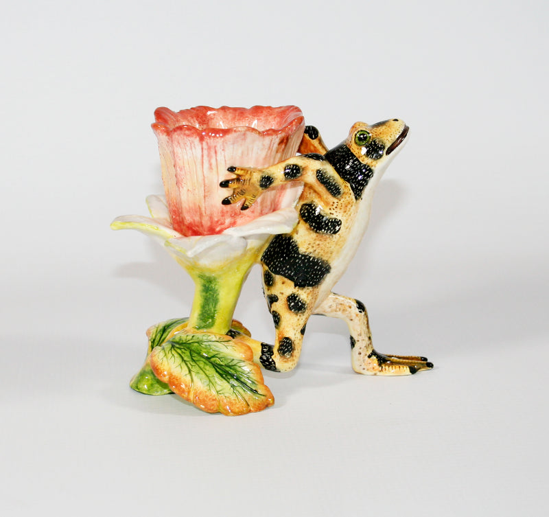 Yellow frog with black speckled stripes and pink flower toothpick holder