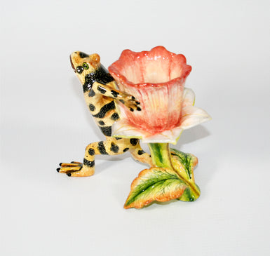 Yellow frog with black speckled stripes and pink flower toothpick holder