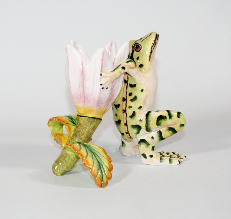 Light green frog with dark green markings and pink yellow flower candle holder