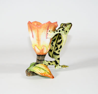 Green frog with black spots and peach, white and yellow base flower candle holder