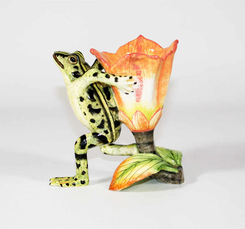 Green frog with black spots and peach, white and yellow base flower candle holder