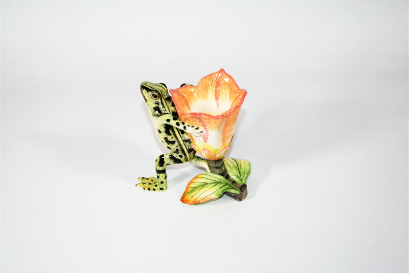 Green frog with black spots and peach, white and yellow base flower candle holder