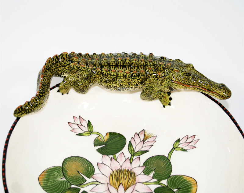 Large decorative bowl on legs with crocodile