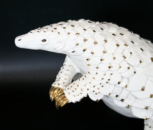 White & Gold Edition Pangolin standing on two hind limbs with curled tail