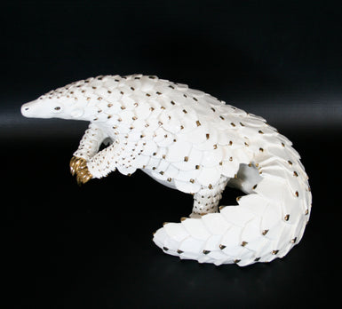 White & Gold Edition Pangolin standing on two hind limbs with curled tail