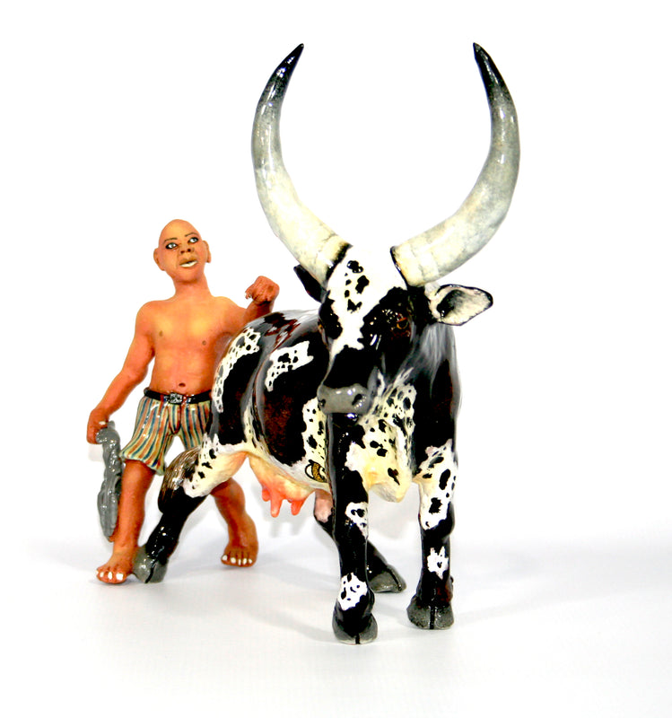 Ankole & shepherd with striped shorts and rope with calf