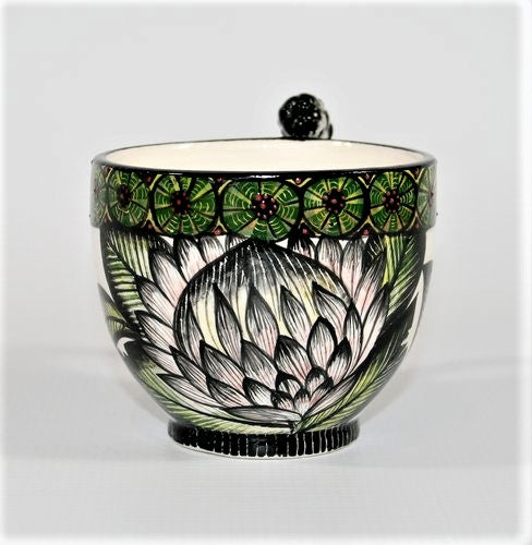 Protea mug with green circle pattern